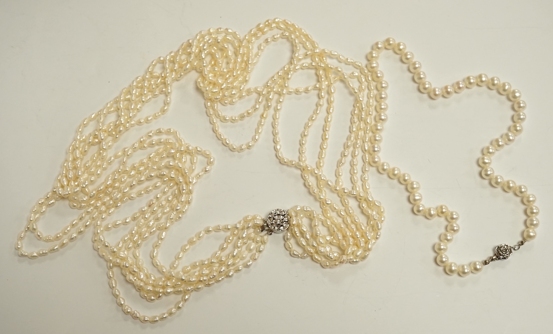 Six assorted modern single strand cultured pearl necklaces, one with 14k clasp, longest 86cm, a pair of similar bracelets, 18cm and a freshwater pearl multi strand necklace. Condition - fair to good